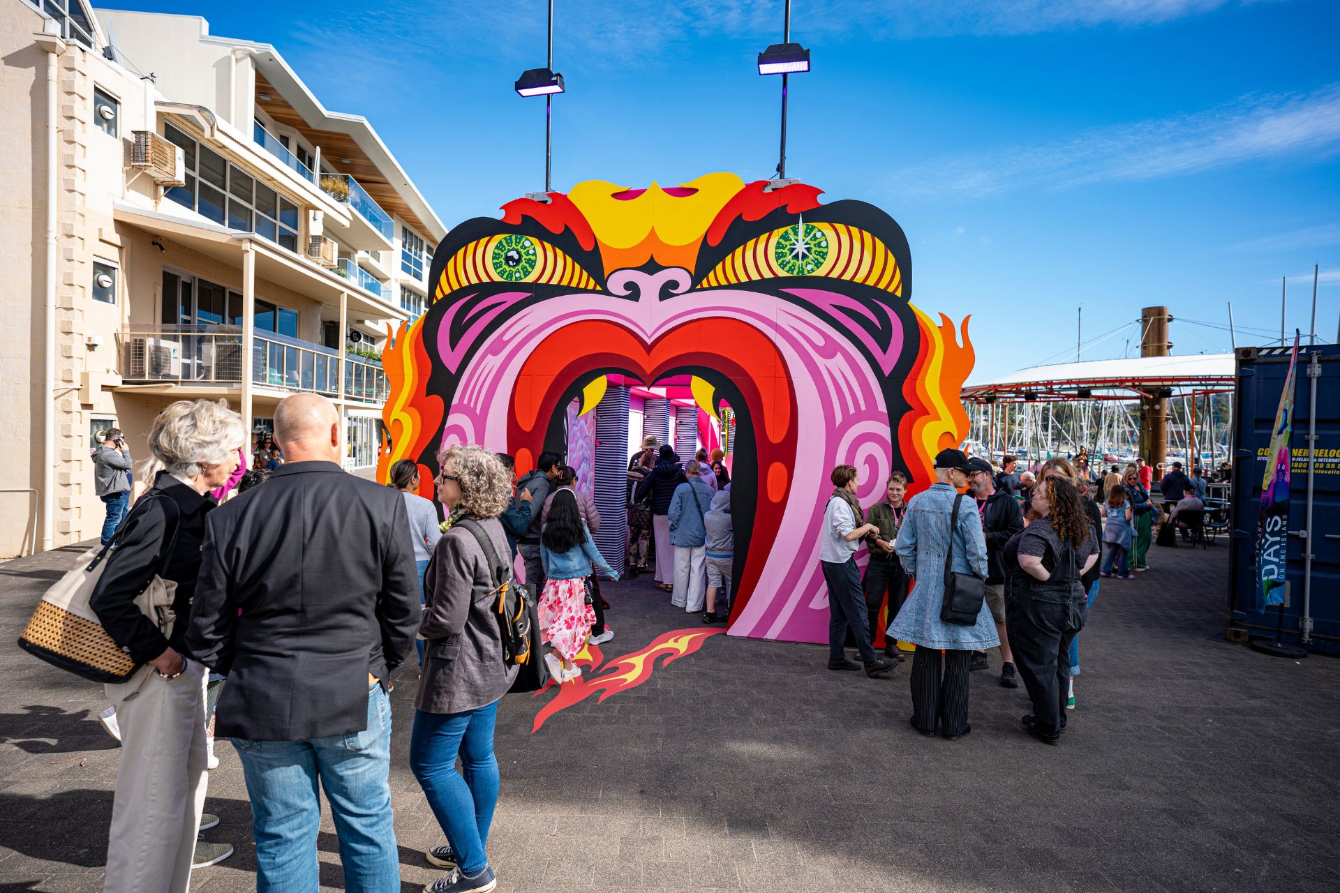 Audience walking through a giant taniwha sculpture at Festival 2023